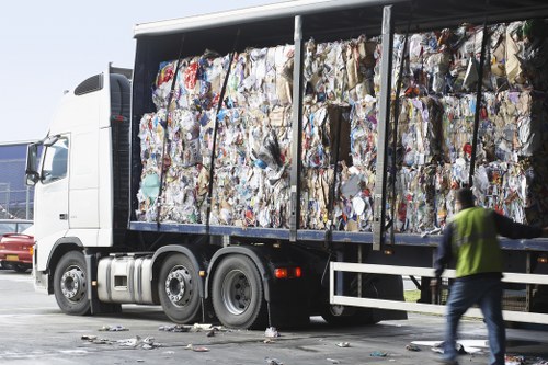 Commercial waste removal trucks in an urban setting.